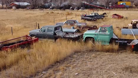 Old-rusty-cars-and-trucks-in-a-over-grown-field-in-the-country-near-Alberta-Canada