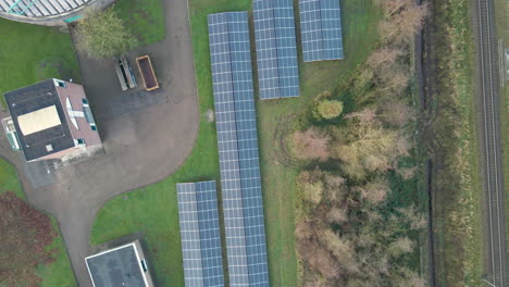 Top-down-aerial-of-solar-panels-on-an-industrial-site