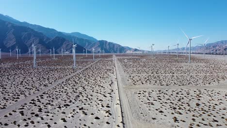 Massive-green-renewable-energy-farm-in-desert-area-of-California,-aerial-fly-forward-view