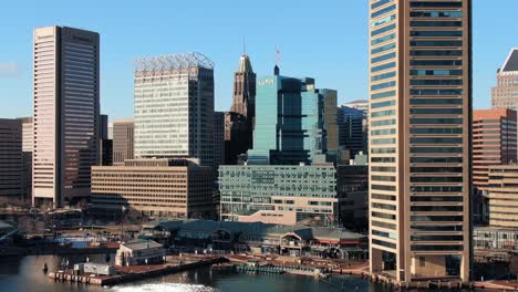 Rising-aerial-reveals-Baltimore-business-district-skyline-located-on-Inner-Harbor,-marina-and-tourist-area
