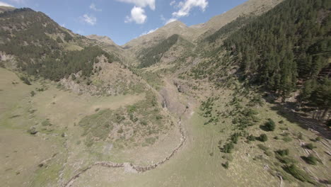 Fast-FPV-aerial-view-across-Esterri-D'aneu-alpine-woodland-valley-in-Catalonia-mountains,-Spain