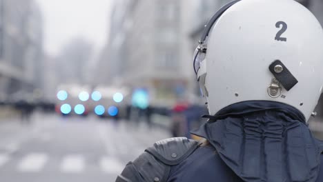 Close-up-Of-Police-Officer-Wearing-White-Helmet-With-Bokeh-Lights-From-Vehicle