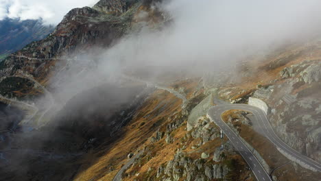 Cinematic-drone-footage-of-the-Susten-Pass-in-the-Swiss-Alps-in-Switzerland-,-coming-out-of-the-clouds