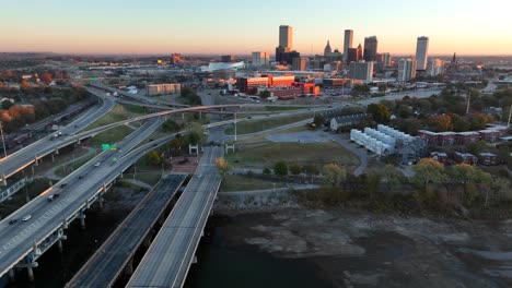 Riverbank-of-Arkansas-River-and-aerial-truck-shot-with-Tulsa-skyline-at-dawn