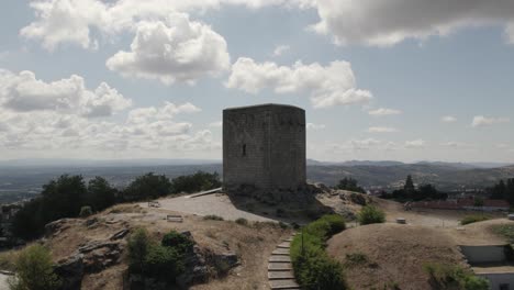 Aerial-orbiting-view-Medieval-Castle-of-Guarda,-old-stone-tower-on-hilltop,-Portugal