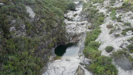Luftaufnahme-Eines-Kleinen-Herzförmigen-Sees,-Versteckt-Zwischen-Den-Felsen-Des-Nationalparks-Peneda-Gerês,-Portugal