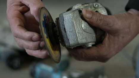 Close-Up-Of-A-Worker's-Hands-Removing-Grinding-Disc-From-An-Angle-Grinder-For-Changing