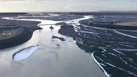 Aerial-panning-shot-of-Sula-Glacial-River-Delta-with-bridge-during-sunny-day-in-Iceland