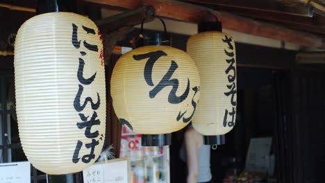 Kunde,-Der-Aus-Einem-Restaurant-Mit-Traditionellen-Asiatischen-Laternen-Geht,-Die-In-Kyoto,-Japan,-Sanfte-Beleuchtung-Hängen