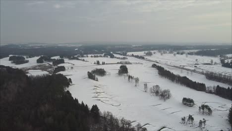 Aerial-Shot-Of-A-Golf-Course-During-Winter,-Fairway-And-Bunkers-Covered-In-Snow