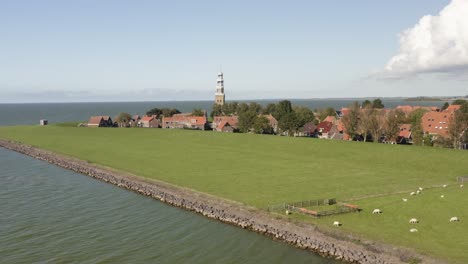 Aerial-shot-of-the-scenic-coastal-town-of-Hindeloopen-in-Friesland,-the-Netherlands,-on-a-beautiful-sunny-summer-day