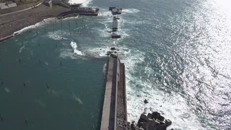 Aerial-view-of-the-waves-destruction-on-the-deactivated-marina-of-Lugar-de-Baixo,-Ponta-do-sol,-Madeira-Ísland,-Portugal