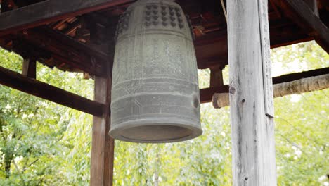 Slide-shot-of-an-old-ancient-bell-in-a-temple-in-Kyoto,-Japan-4K-slow-motion