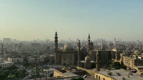 Cairo-Skyline-Pictures,-The-Mosque-Madrassa-of-Sultan-Hassan-and-the-Pyramids-in-the-background,-Cairo,-Egypt
