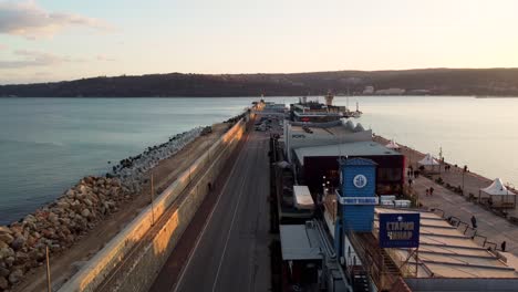 Drone-flying-over-Port-of-Varna-during-sunset-with-cars-passing-by