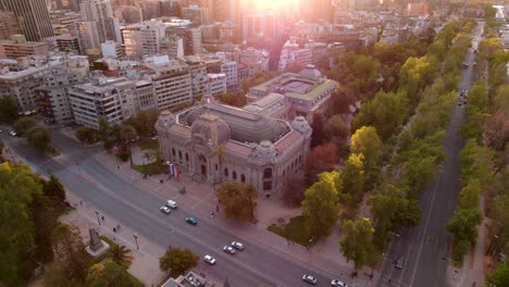 Aerial-view-dolly-in-the-National-Museum-of-Fine-Arts-with-the-sun-glinting-on-the-horizon,-Santiago,-Chile