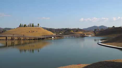 Travelers-walking-on-spiral-walkways-of-Bonghwa-Hill-and-Bridge-of-Dreams-in-Suncheonman-Bay-Lake-Garden,-Suncheon-city,-Jeonnam,-South-Korea