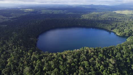 Lake-Eacham-With-Tropical-Rainforest-In-Atherton-Tableland,-Queensland,-Australia---aerial-drone-shot