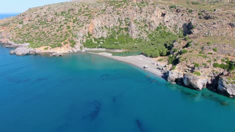 Cinematic-aerial-shot-revealing-the-mountains-around-Preveli-and-mediterranean-sea