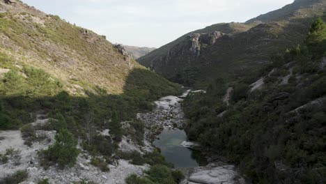 Aerial-footage-of-a-little-river-in-the-mountains-valley-of-peneda-geres-national-park-north-of-Portugal