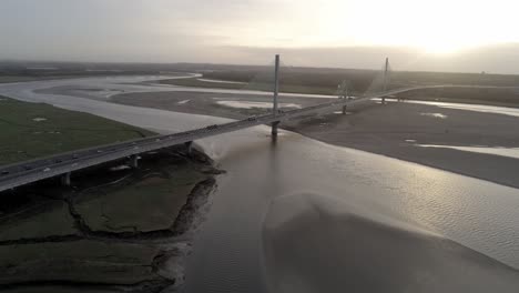 Aerial-view-above-River-Mersey-skyline-Gateway-suspension-bridge-at-sunrise