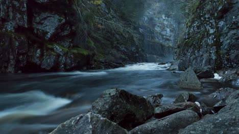 Mystic-river-flow-and-rock-foreground-timelapse-dawn