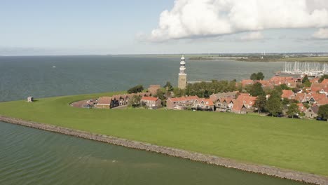 Aerial-shot-of-the-scenic-coastal-town-of-Hindeloopen-and-marina-in-Friesland,-the-Netherlands,-on-a-beautiful-sunny-summer-day
