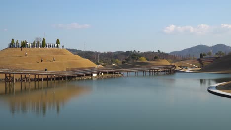 Visitors-strolling-around-Bonghwa-Hill-and-Bridge-of-Dreams-in-Suncheonman-Bay-Lake-Garden,-Suncheon-city,-South-Korea