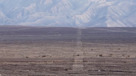 Many-small-Nazca-lines-zoom-in,-from-beginig-crossing-the-highway-to-mountain-range-4k