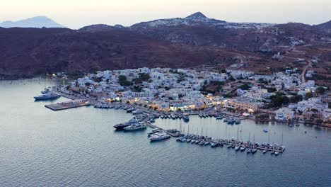 Night-Aerial-Adamantas-Port-Town-in-Milos-Island,-Greece