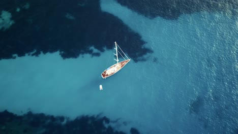 Stunning-drone-footage-in-4k-of-a-big-sailing-yacht-in-crystal-clear-blue-turquoise-water-in-the-mediterranean-sea---Majorca-yachting
