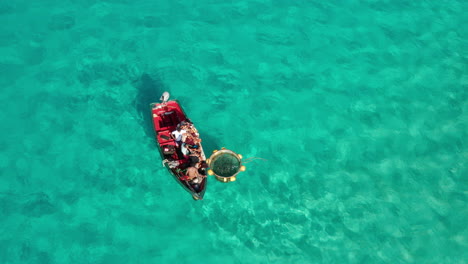 Top-down-view-of-African-fishermen-fishing-in-colorful-turquoise-water