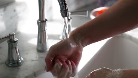 Man-Washing-Soap-Off-Of-Hands-In-Slow-Motion