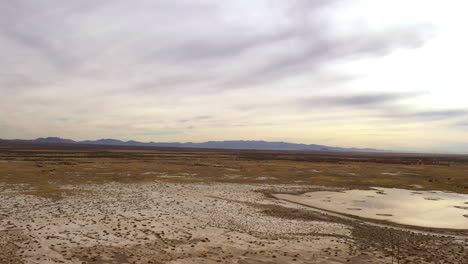 Willcox-Playa,-ancient-lakebed-covered-in-mud,-drone-shot-flying-forward