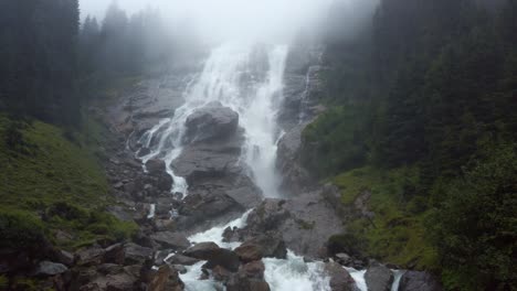 Tilt-shot-of-the-Grawa-Waterfall-on-a-cloudy-rainy-day-in-Stubai-Valley-Tyrol,-Austria