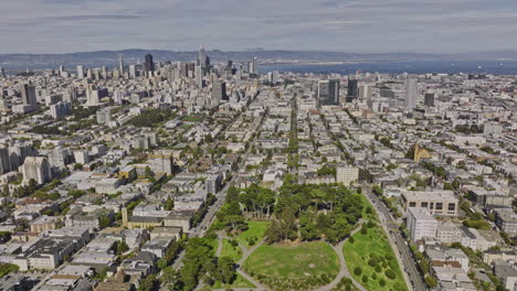 San-Francisco-California-Aerial-v169-flyover-alamo-square-urban-park-capturing-cityscape-by-the-bay,-tilt-down-birds-eye-view-of-iconic-painted-victorian-houses---Shot-with-Mavic-3-Cine---June-2022