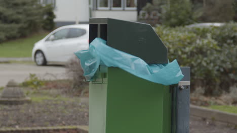 Müllsack-Aus-Plastik-In-Grünem-Mülleimer,-Der-Im-Wind-Flattert---Nahaufnahme