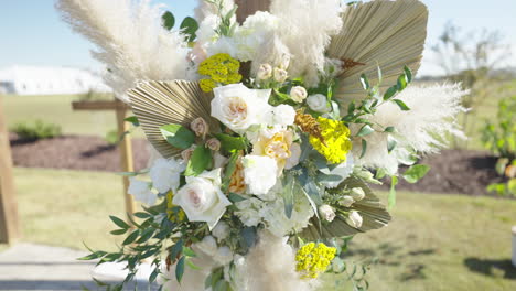 Flower-bouquet-at-wedding-venue-blowing-in-the-wind