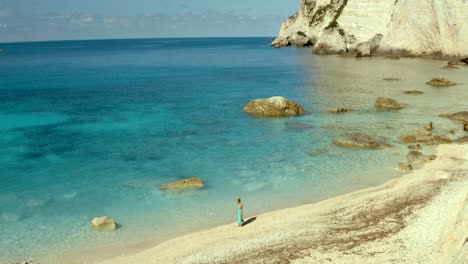 Woman-Walking-in-Solitude-on-Secluded-Erimitis-Bay-Beach-in-Paxos,-Greece