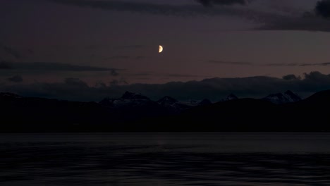 Beautiful-time-lapse-of-the-moon-watching-over-sea-and-mountain-view