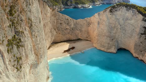 Incredible-Aerial-Establishing-View-over-Famous-Navagio-Shipwreck-Beach-in-Greece