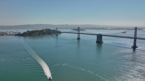 San-Francisco-California-Aerial-v140-panning-view-of-treasure-island-and-yerba-buena,-drone-flyover-and-around-bay-bridge-spanning-across-the-estuary-on-a-sunny-day---Shot-with-Mavic-3-Cine---May-2022