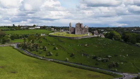 A-drone-rising-location-shot-of-The-Rock-of-Cashel-which-is-the-ancient-seat-of-those-who-ruled-the-province-of-Munster-in-Ireland-in-times-before-the-Norman-invasion
