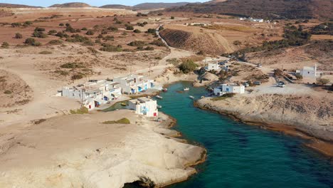 Milos-fisherman-village-huts-houses,-drone-dolly-out-shot-in-Greek-travel-destination