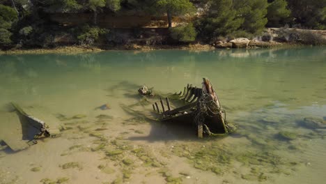 Sunken-skeleton-boat-abandoned-in-still-waters,-Static-Shot