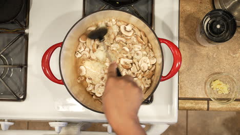 Sauteing-organic-sliced-mushrooms-in-a-pot-over-the-stove-for-a-vegan-recipe---overhead-view-WILD-RICE-SERIES