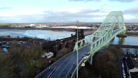 Charity-Santa-dash-fun-run-over-Runcorn-Silver-Jubilee-bridge-Aerial-view-dolly-left-wide-shot