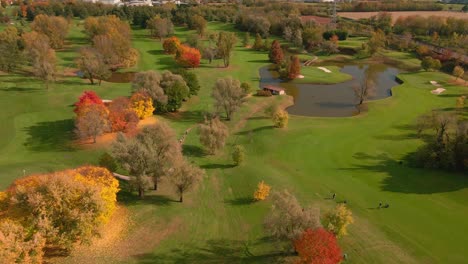 Aerial-View-Of-Scenic-Golf-Course-with-Ponds-and-Green-Grass-during-Autumn---drone-shot