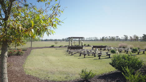 Romantic-wedding-ceremony-venue-pews-set-up-outdoor-field