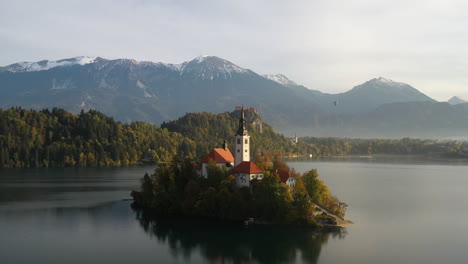 Epic-cinematic-drone-footage-of-the-Pilgrimage-Church-of-the-Assumption-of-Mary,-Slovenia-during-the-golden-hour
